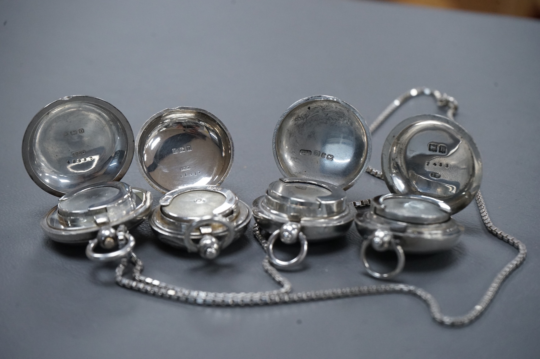 Two late Victorian plain silver sovereign cases and two George V silver sovereign cases, including engine turned, Birmingham, 1913, with a later associated silver chain.